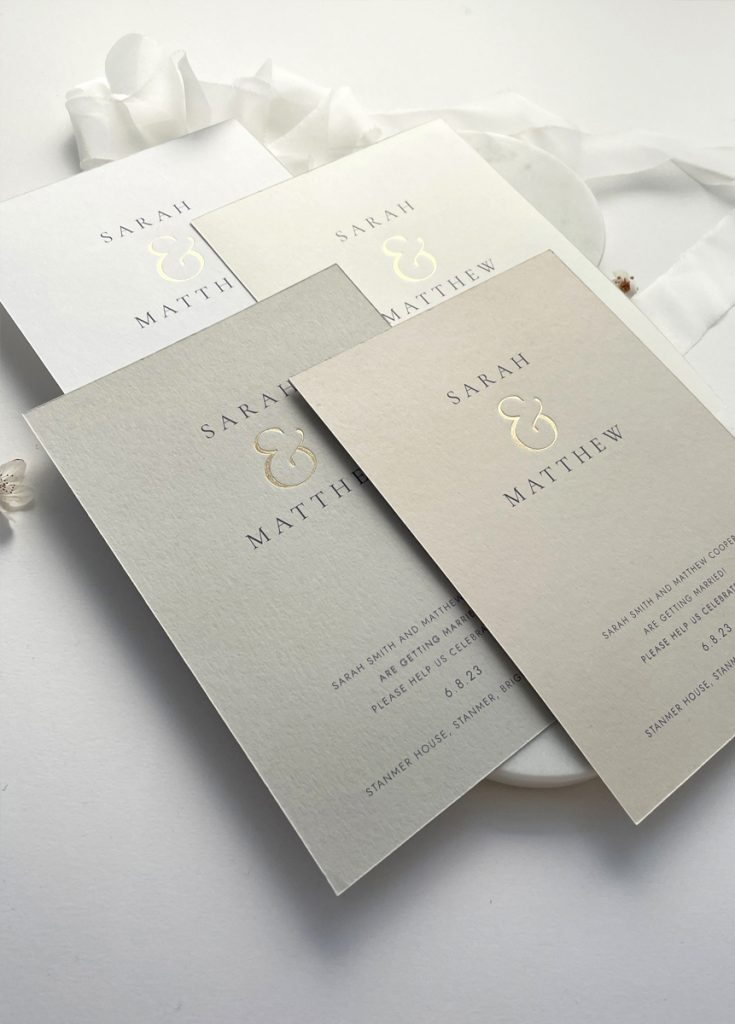 Gold foil luxury wedding invitation with an elegant ampesand in gold foil on a choice of luxury card: white, ivory, nude and pale grey
