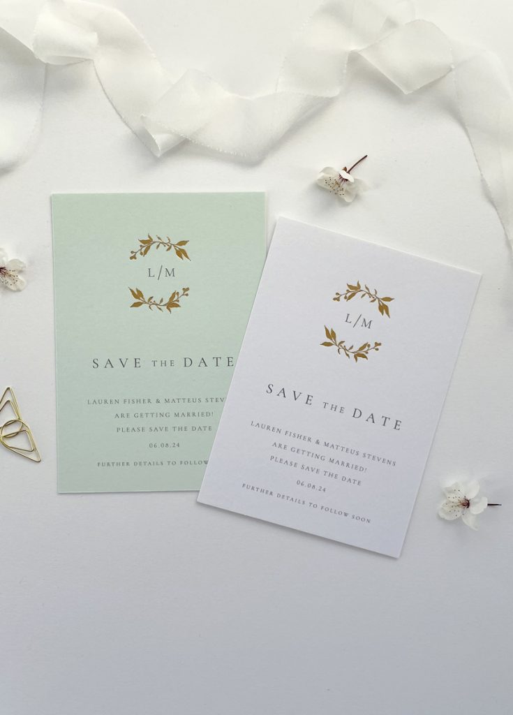 Botanical wreath wedding invitation save the date with an elegant floral wreath and monogram of your initials inside it. Available on white of pale green card
