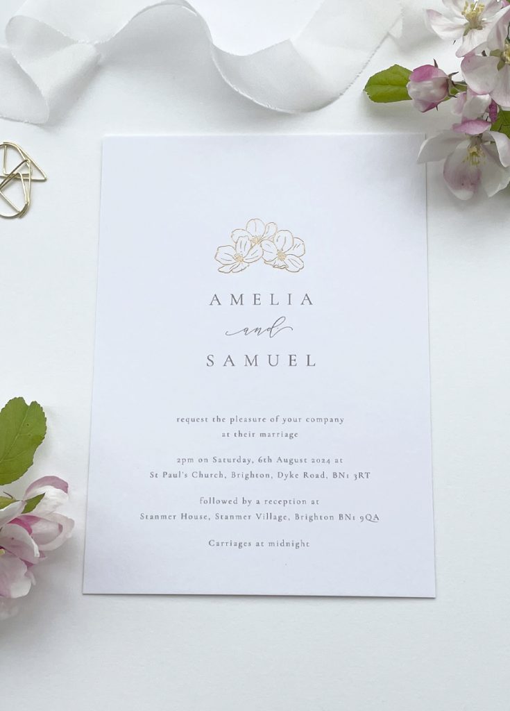 Luxury gold foil wedding invitation with botanical floral blossom illustration in gold with minimalist type