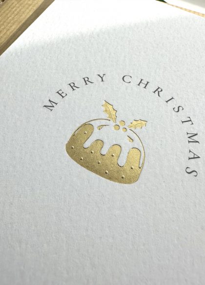close up of luxury festive gold foil christmas pudding chrismas card