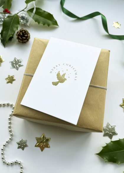 Luxury gold foil dove Christmas card with Merry Christmas message on textured white cardstock and grey envelope.