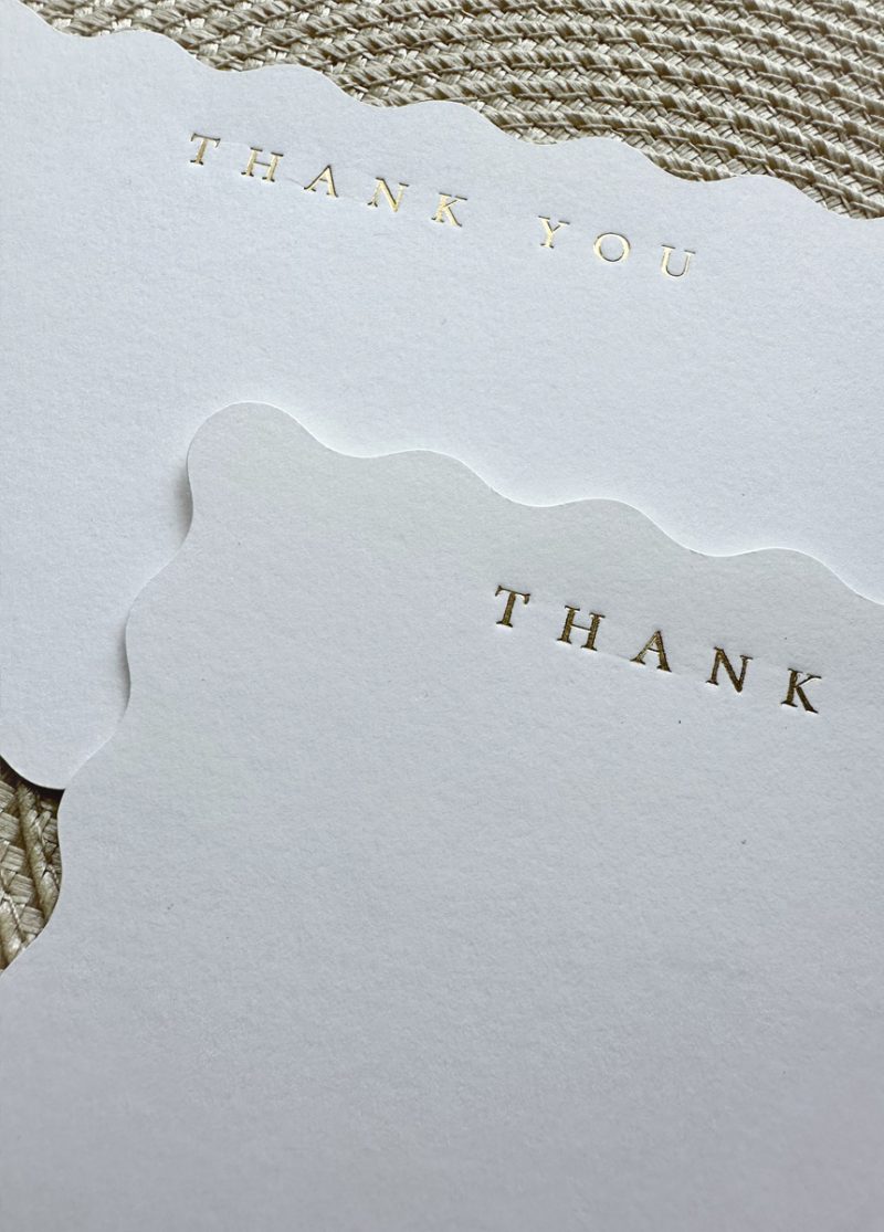 close up of gold foil wedding thank you notecards