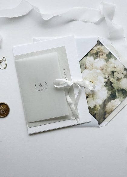 Romantic vellum wedding invitation wallet with personalised initials and silk ribbon finish