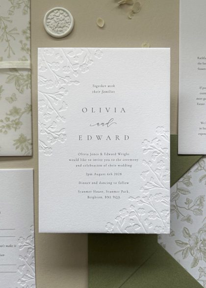 Luxury floral embossed wedding invitation suite with sage green envelope and botanical envelope liner printed on thick cotton card.