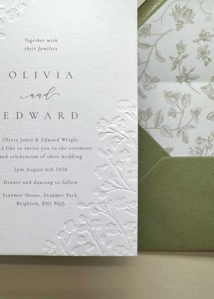Luxury floral embossed wedding invitation suite with sage green envelope and botanical envelope liner printed on thick cotton card.