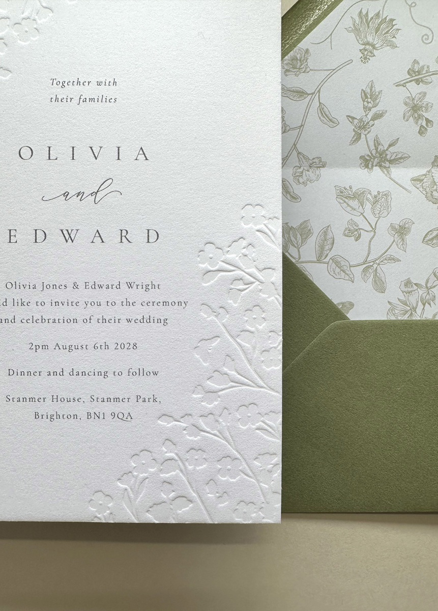 Luxury floral embossed wedding invitation suite with sage green envelope and botanical envelope liner printed on thick cotton card.
