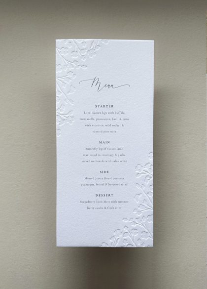 Luxury floral embossed wedding menu printed on thick cotton cardstock with elegant botanical detailing and timeless typography.