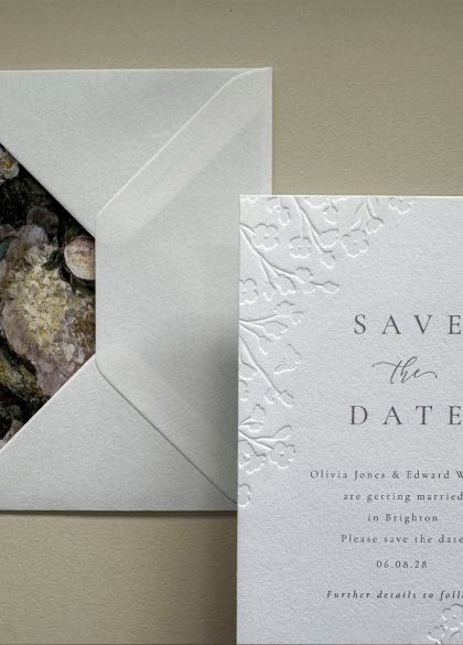 Close-up of the floral embossed Save the Date card showcasing the delicate embossed botanical design on luxurious thick cotton cardstock.