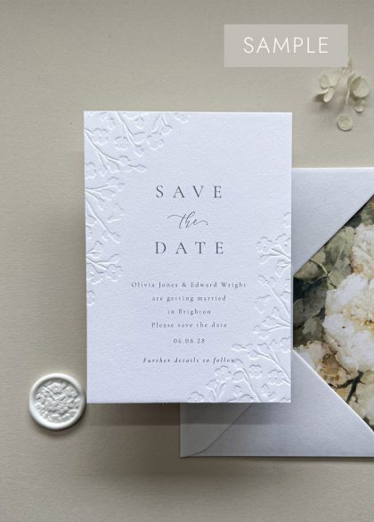 Matching floral embossed Save the Date from the luxury wedding stationery collection, coordinating with wedding invitations, RSVP cards and on-the-day stationery.